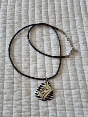 Black Cord Necklace with A Black And White Guitar Pick and Silver Cassette Charm